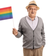Older adult male holding rainbow flag